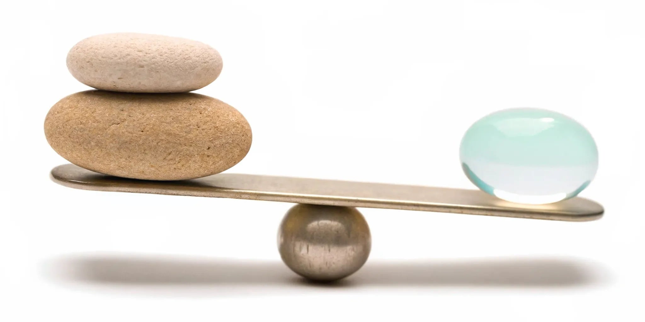 Stones and a sphere balanced on a beam, a key to mood balance for emotional stability.