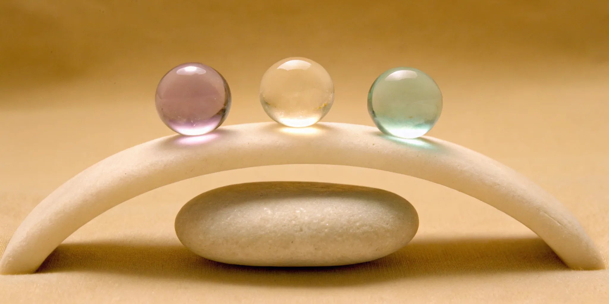 Colored spheres balanced on stones for mood balance with hormonal changes.