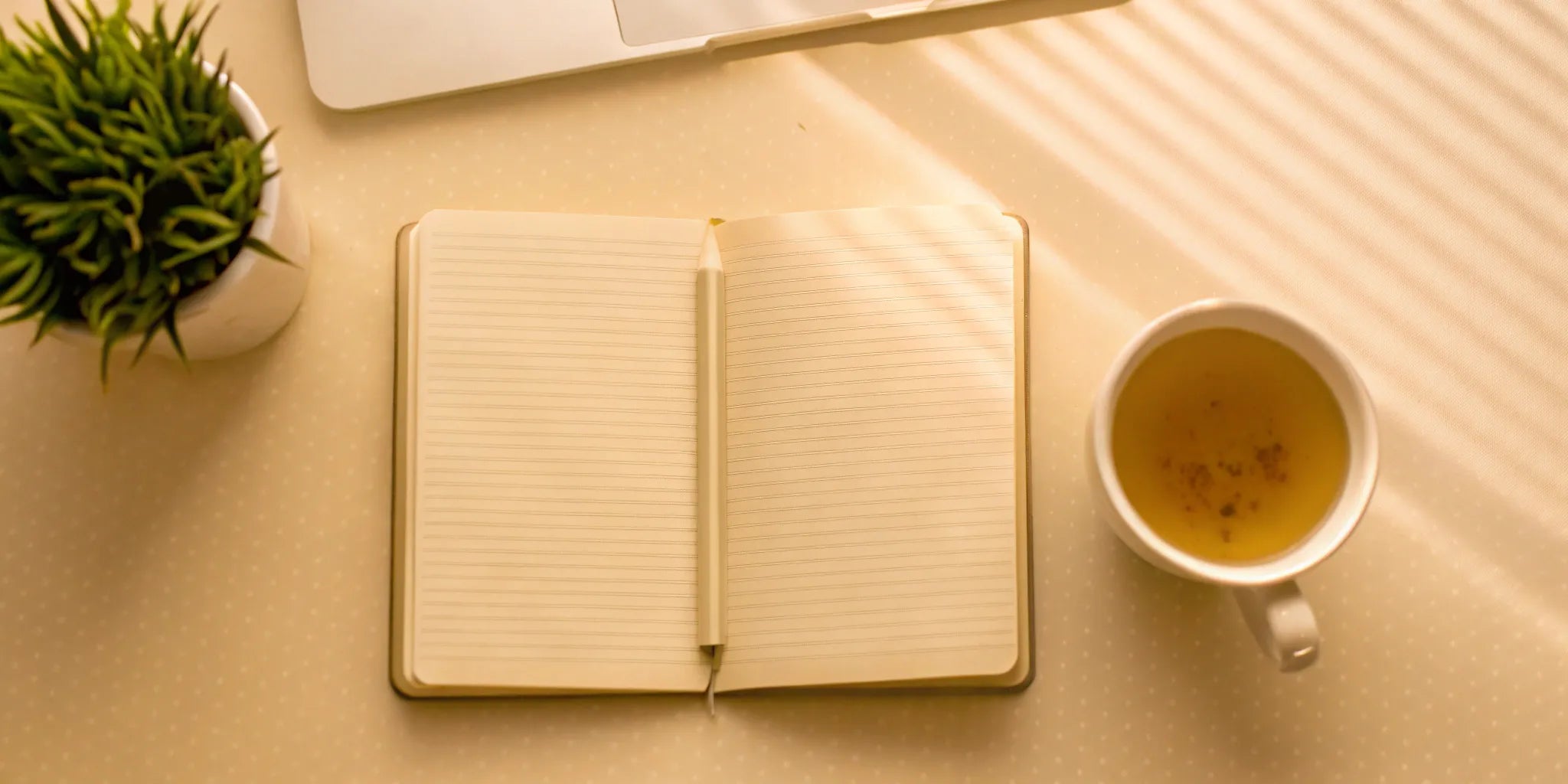 A notebook and pen used to research the best supplements for mental clarity.