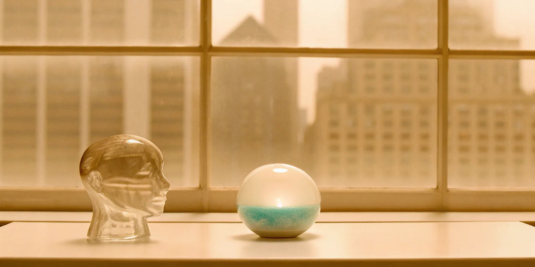 A clear glass head and balancing orb show how mood balance clears brain fog.