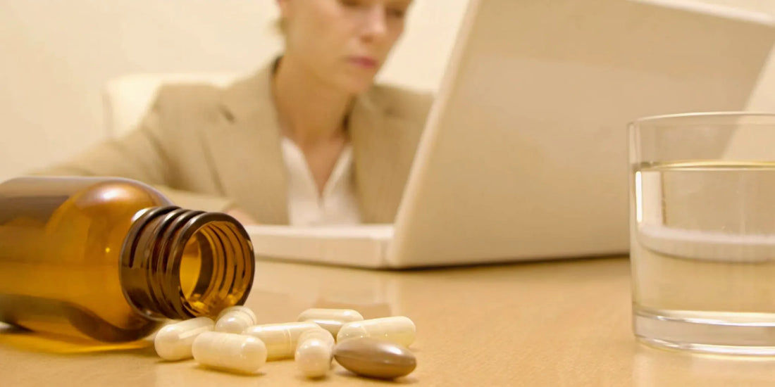 Probiotic capsules on a desk, answering if probiotics can cause headaches and dizziness.
