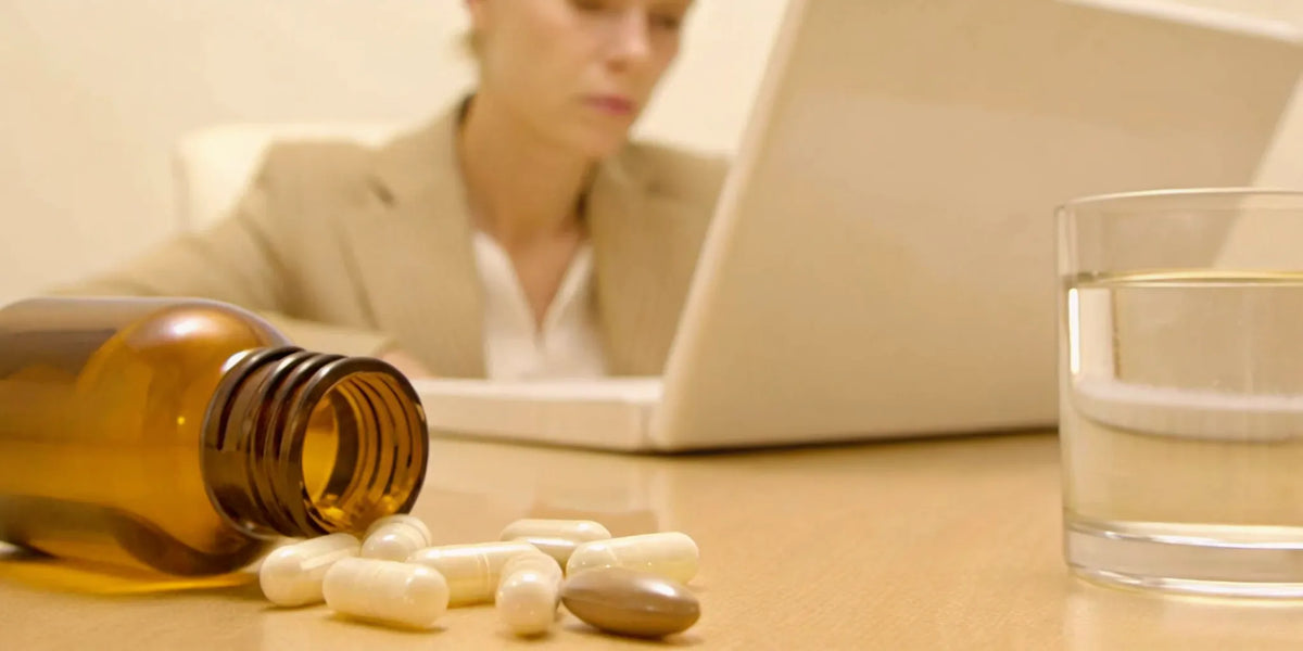 Probiotic capsules on a desk, answering if probiotics can cause headaches and dizziness.