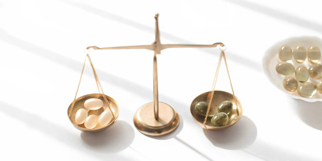 A gold balance scale weighing different mood balance supplements.
