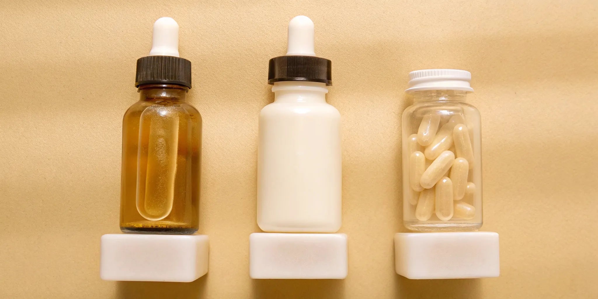 Various probiotic supplements for gut health, including capsules and a liquid dropper.