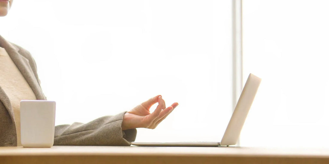 A person at a desk using mindfulness for mood balance and gut inflammation.