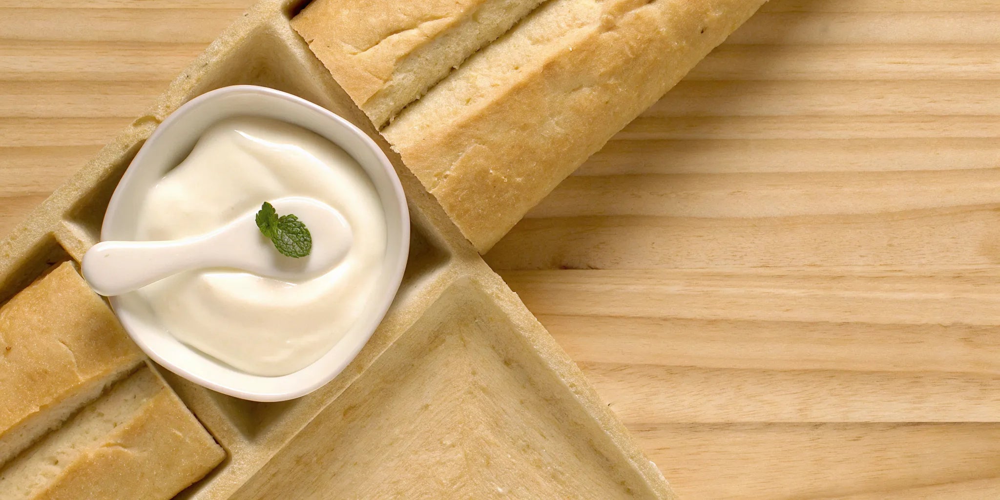 A bowl of yogurt, a fermented food that helps increase postbiotics naturally.