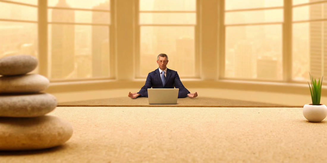 A man meditating at his desk, finding mood balance for men.