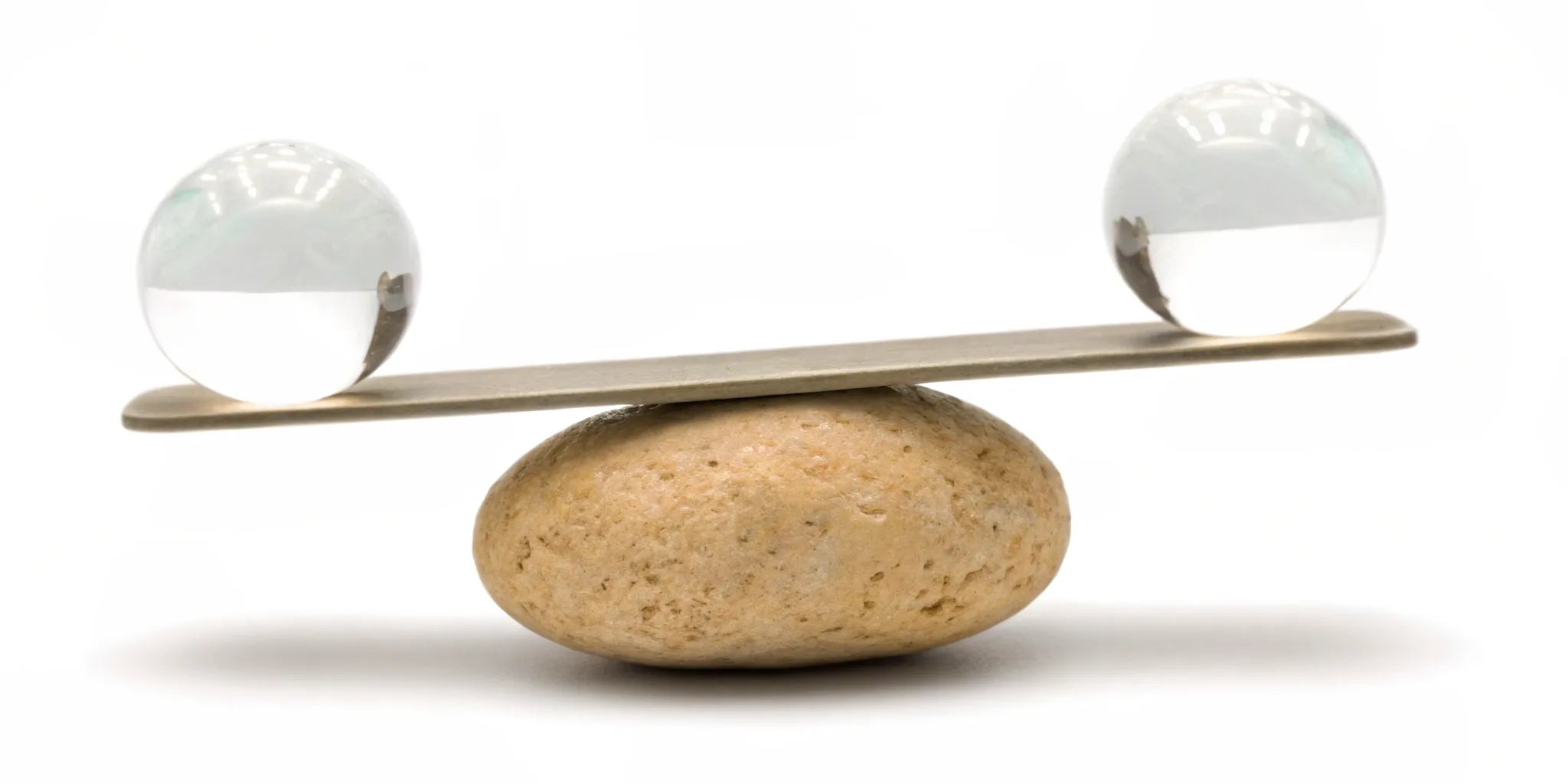 Glass spheres in perfect balance on a stone for mood balance and mental clarity.
