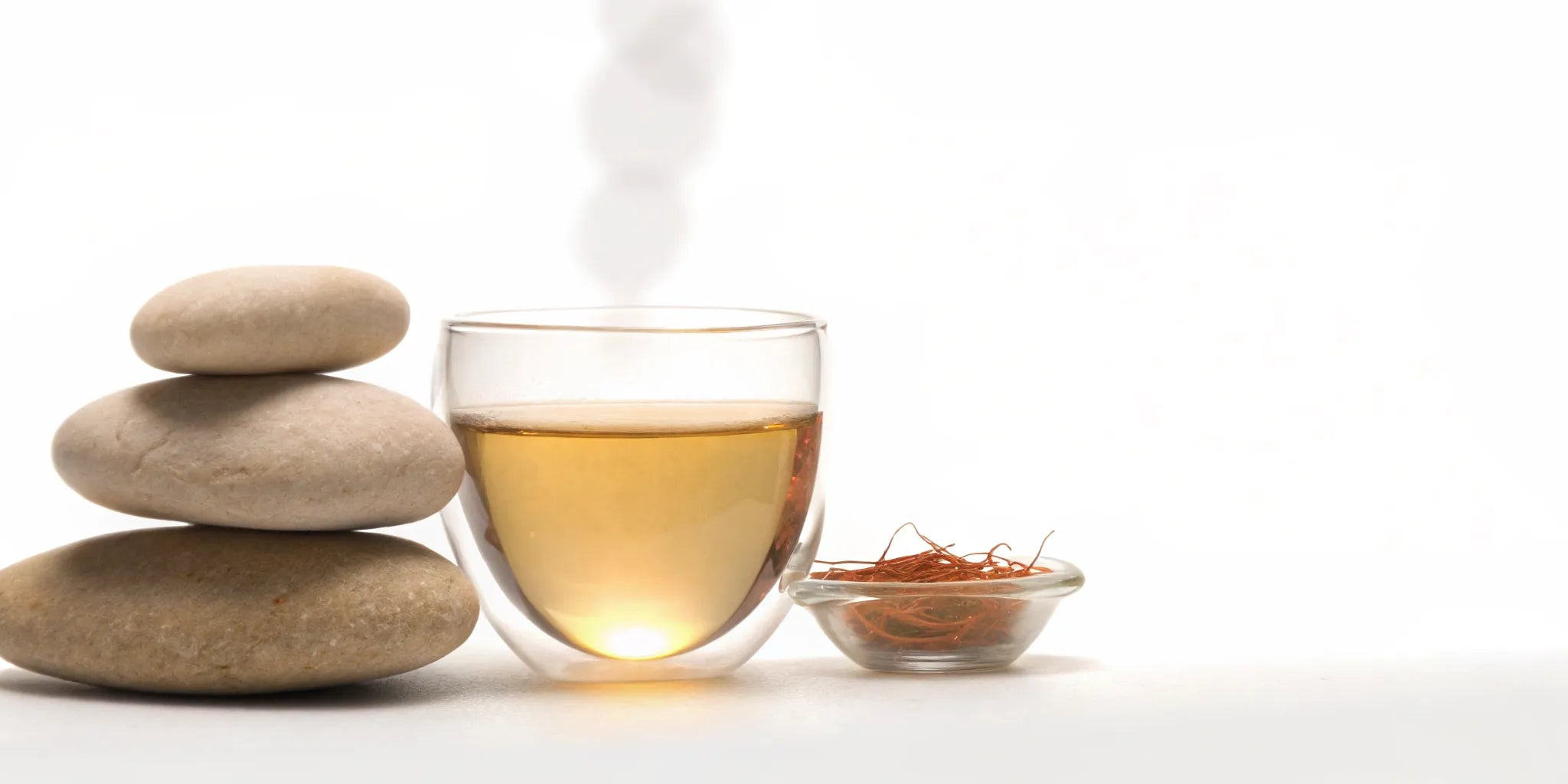 Saffron tea and threads with balanced stones for mood balance.