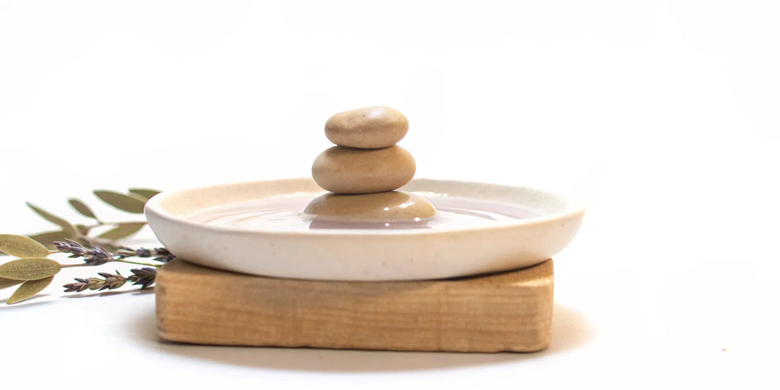 A stack of balanced stones in water for natural mood balance.