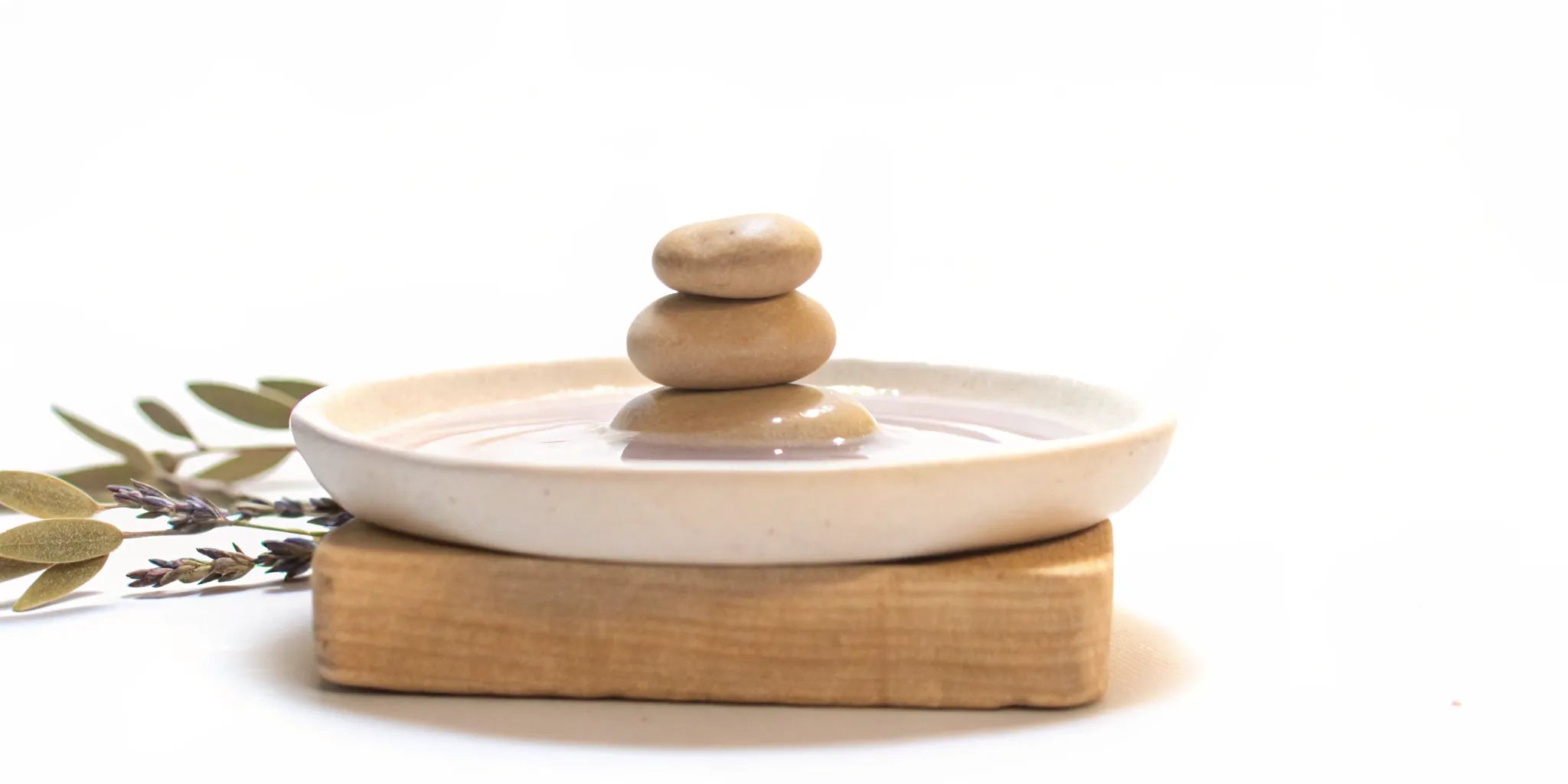 A stack of balanced stones in water for natural mood balance.