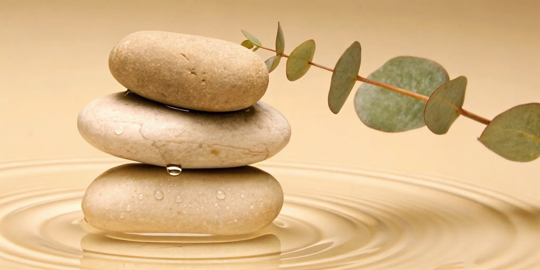 Natural non-habit-forming mood balance with stacked stones and a eucalyptus branch.