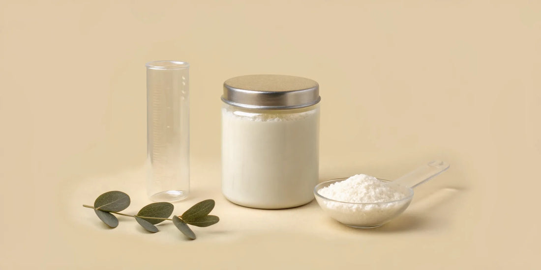 Postbiotic powder supplement in a jar with a measuring scoop.