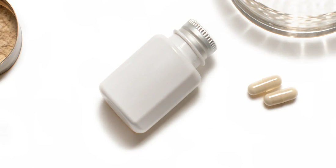 Bottle and capsules of postbiotic supplement for gut health.