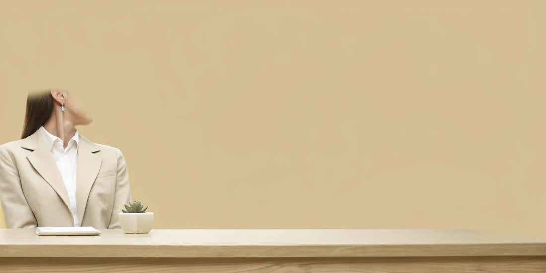 Woman at her desk enjoying the gut and mental health benefits of postbiotics for women.