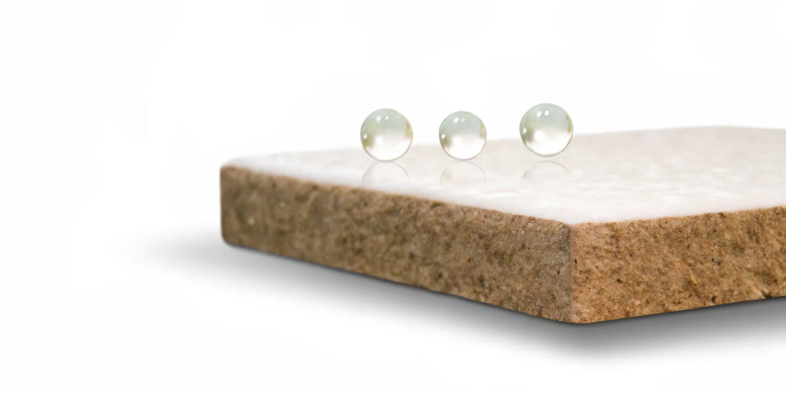Water droplets on a stone surface for a comparison of postbiotics vs butyrate.