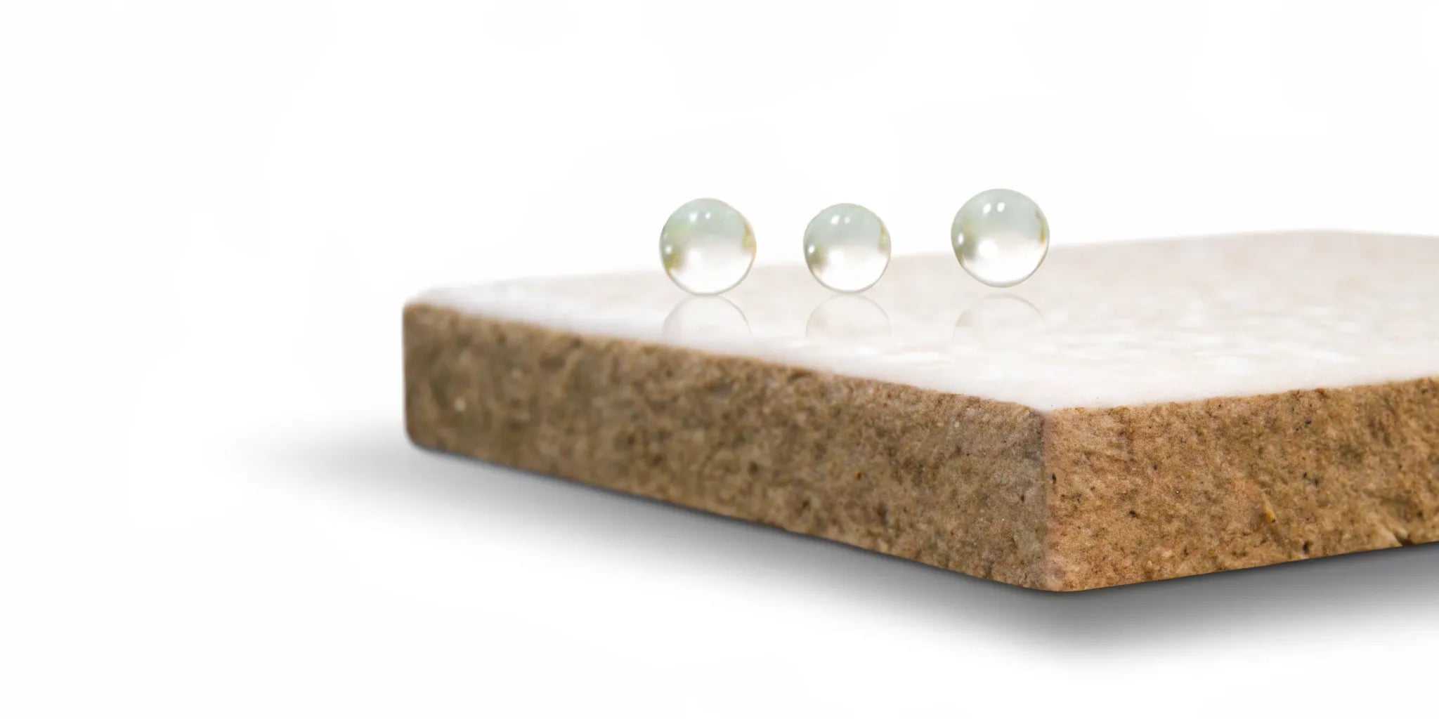 Water droplets on a stone surface for a comparison of postbiotics vs butyrate.
