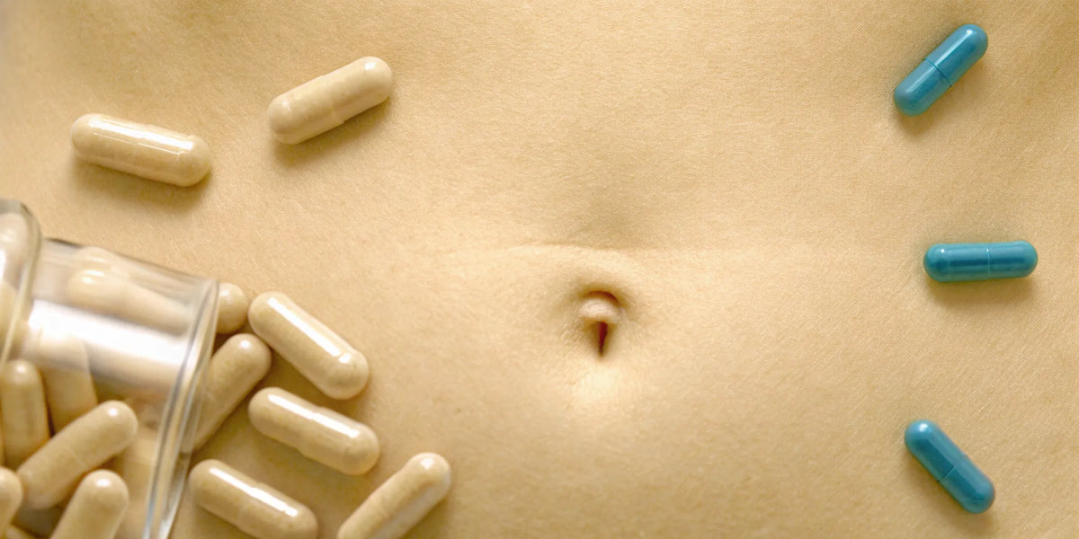 Probiotic capsules on a stomach, a visual of the probiotic withdrawal symptoms discussed on Reddit.