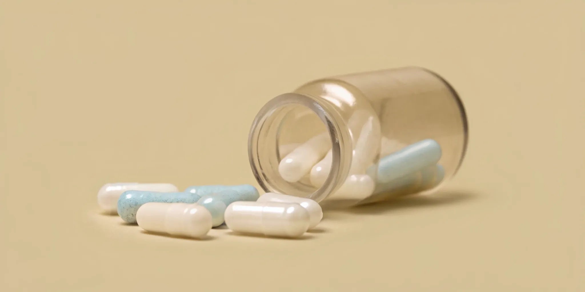 Side effects of stopping probiotics shown by a spilled bottle of capsules.