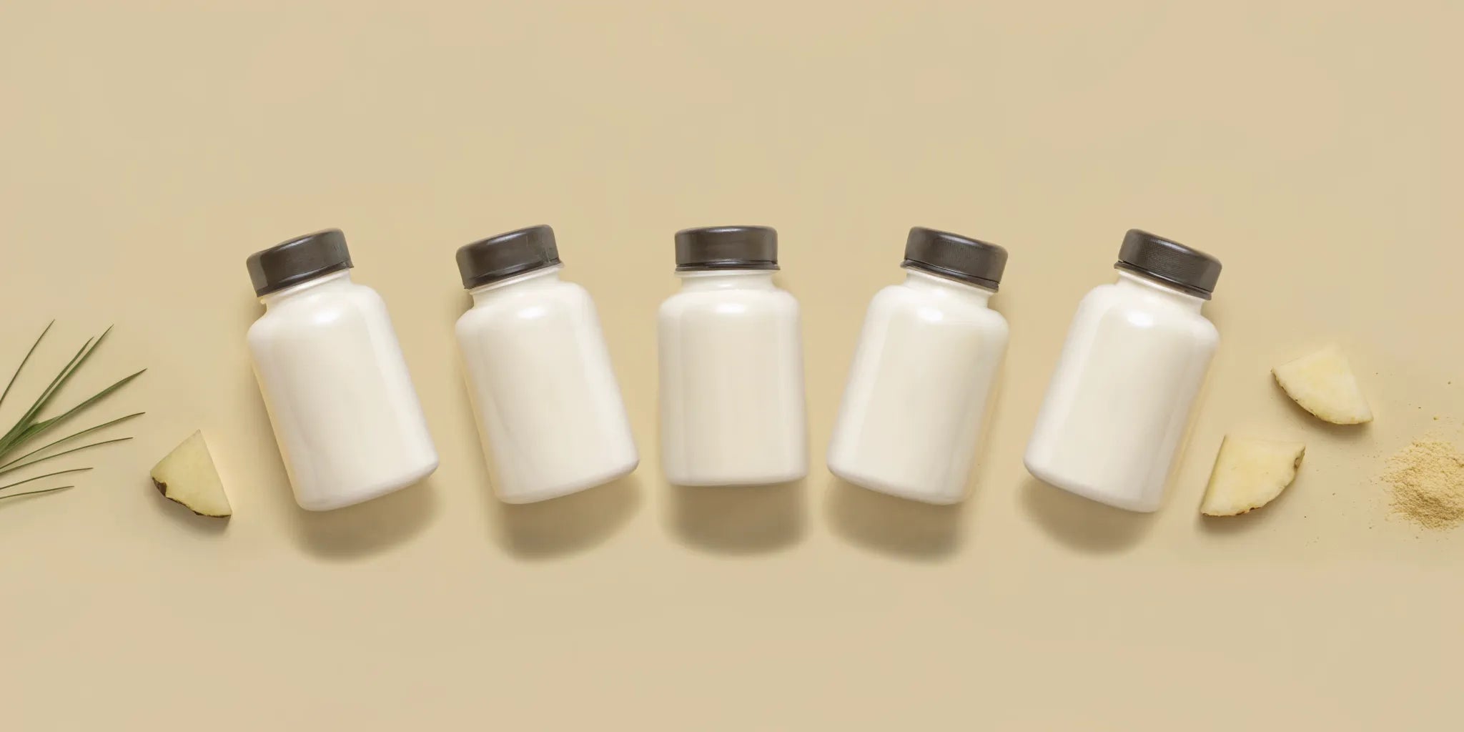 Bottles of the best digestive enzymes for bloating and gas relief, with plants and ginger accents.
