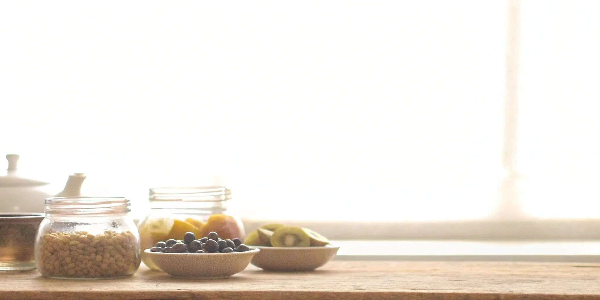Jars and bowls with the best supplement ingredients for gut health and bloating.