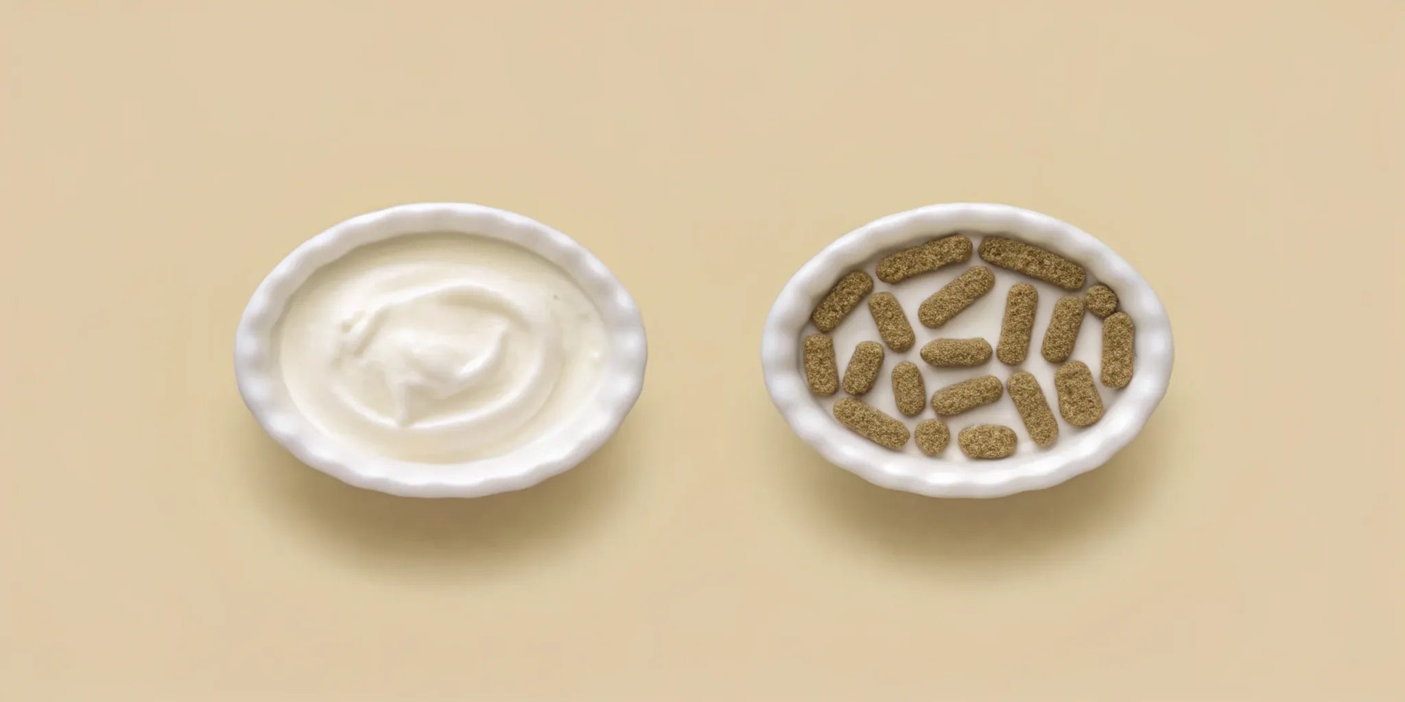 A bowl of yogurt next to a bowl of the best gut health supplement capsules.