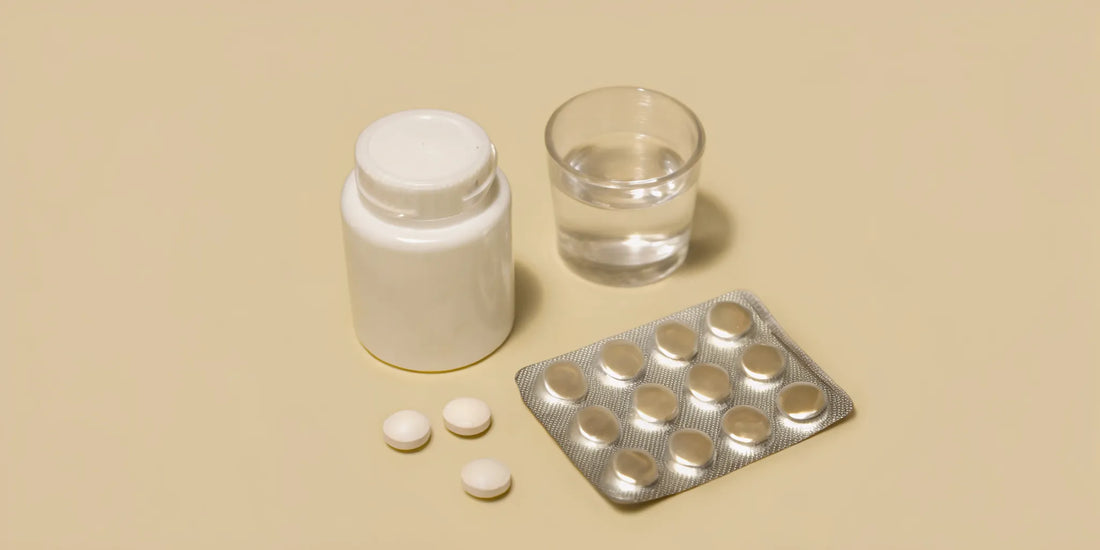 A bottle and blister packs of over the counter medicine for a bloated stomach.