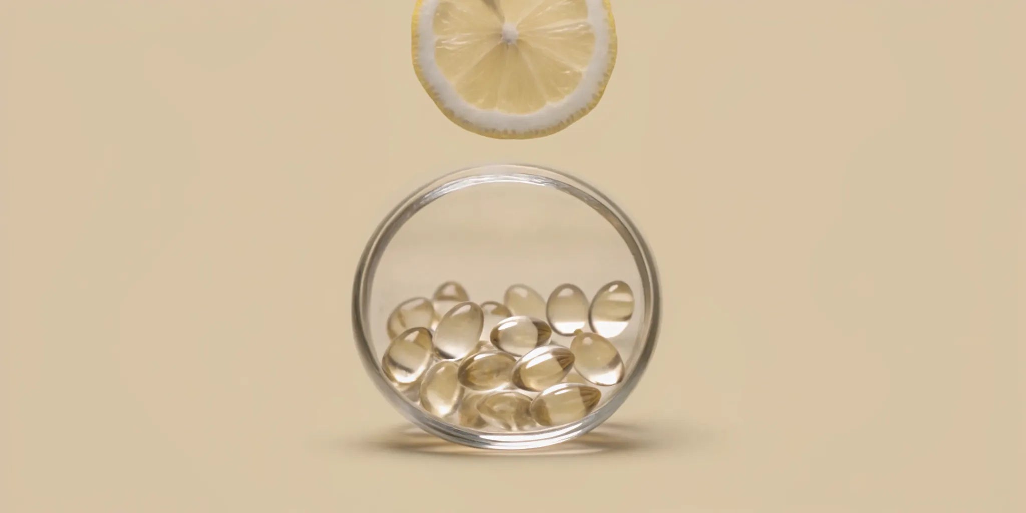 Glass jar of vitamins for digestion and metabolism with a lemon slice.