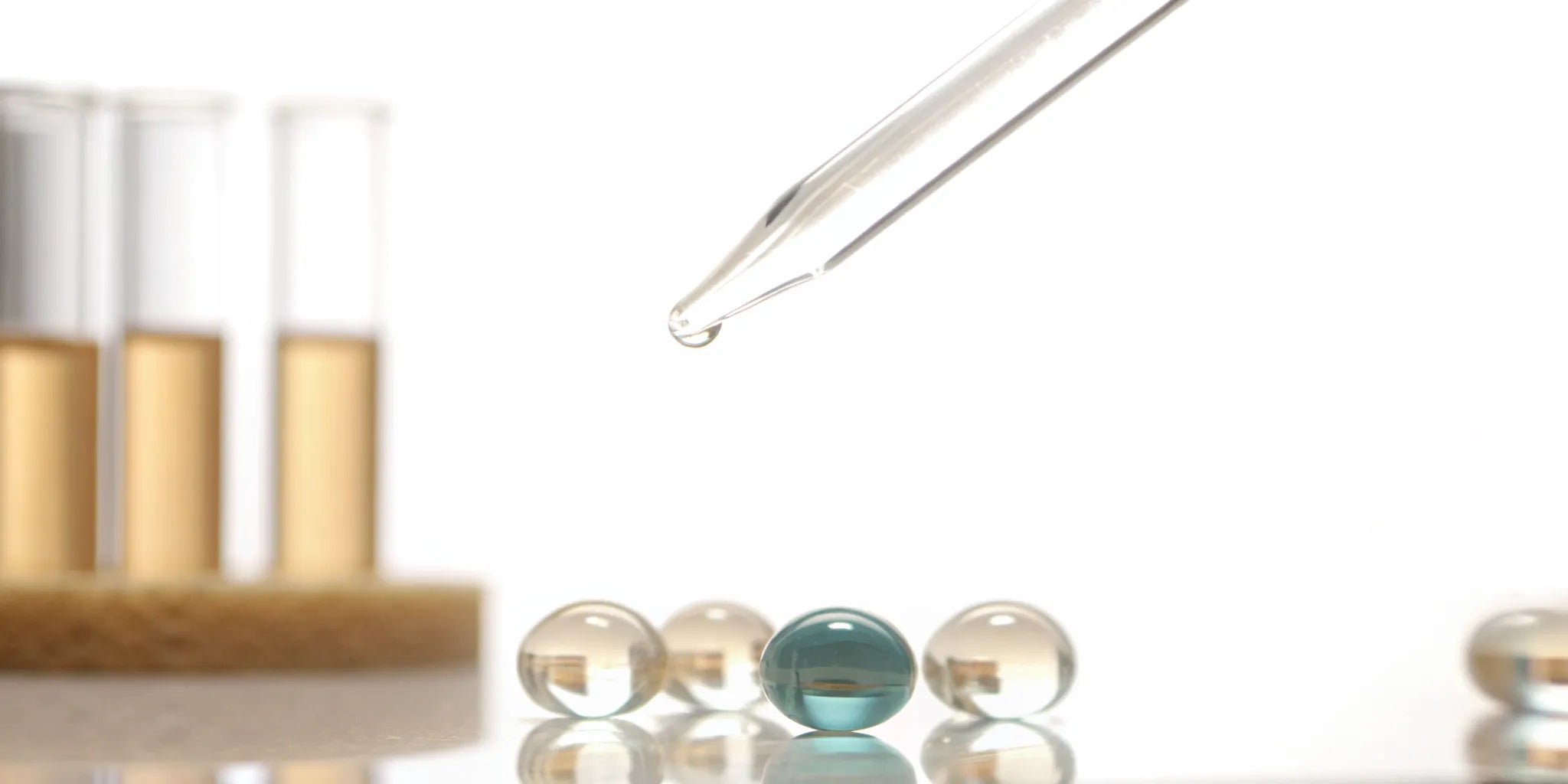Probiotic metabolite supplement with a pipette, test tubes, and clear capsules.