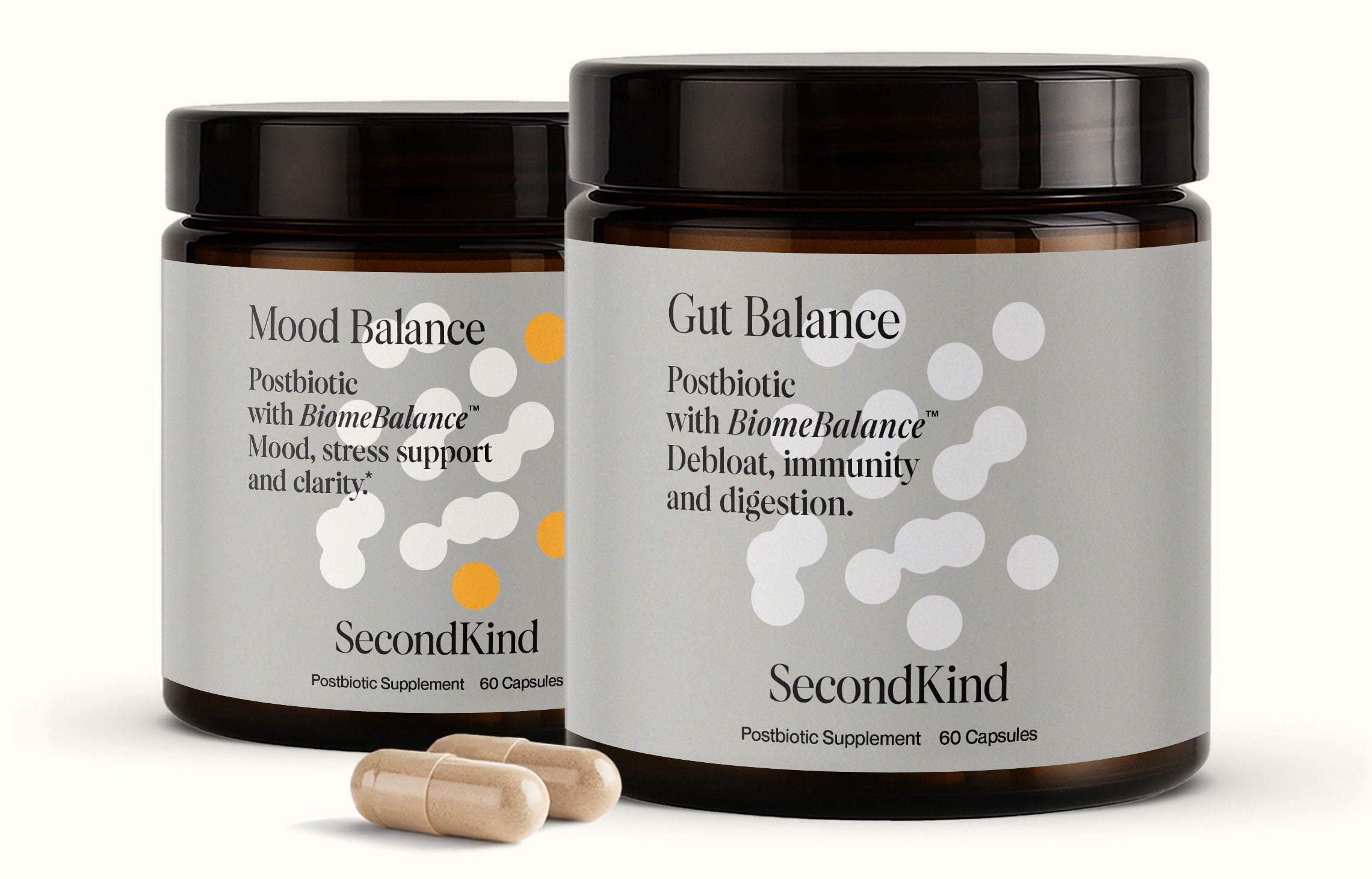 Two brown jars of the Gut and Mood Balance Bundle by SecondKind, each containing 60 postbiotic capsules, highlight the gut–brain axis connection. Two beige capsules are placed in front of the jars.