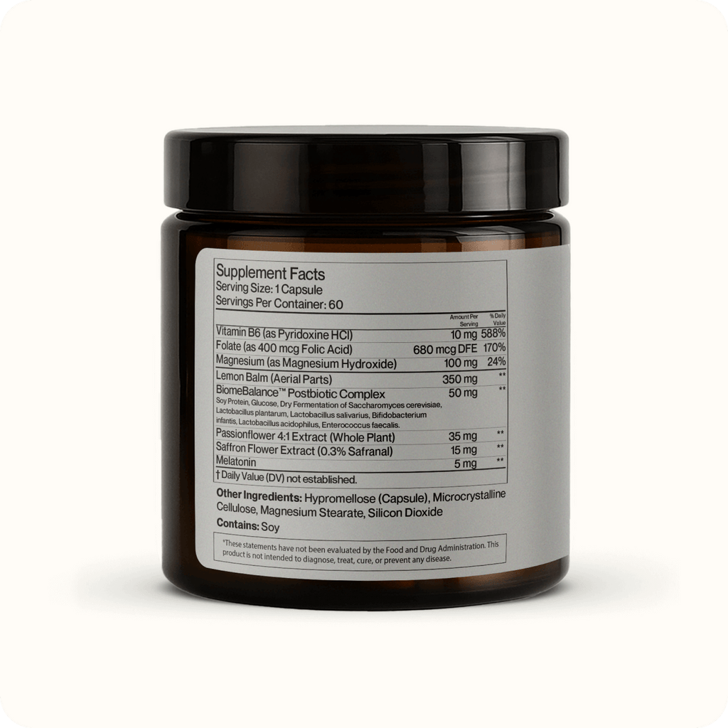 A brown jar labeled "Mood Balance" shows supplement facts, ingredients, and serving size in black text on a white label. This postbiotic supplement is set against a plain light background and supports emotional balance.