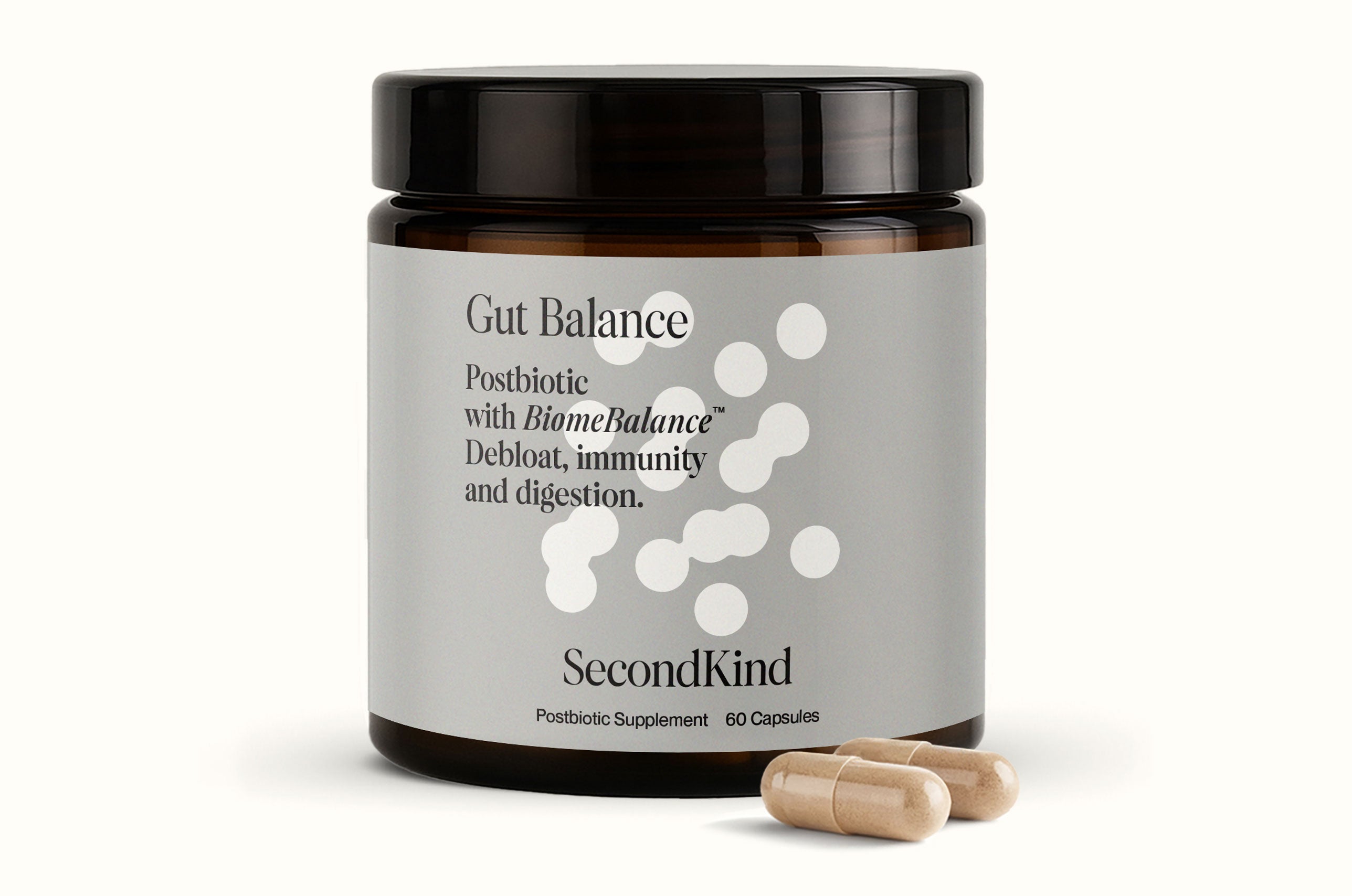 A brown jar labeled Gut and Mood Balance Bundle by SecondKind with white text describes a postbiotic supplement for digestion and gut–brain axis support, with two beige capsules in front of the jar.